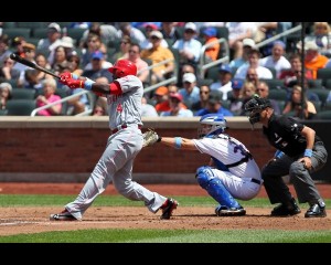 June 17, 2012; Flushing, NY,USA; Cincinnati Reds second baseman Brandon Phillips (4) singles to right allowing a runner to score during the fifth inning against the New York Mets at Citi Field. Mandatory Credit: Anthony Gruppuso-US PRESSWIRE