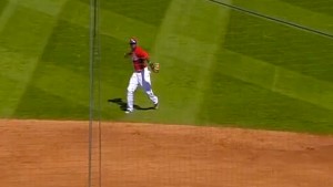 Brandon Phillips grabs a bouncing ground ball with his bare hand and throws to first for the out. 