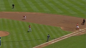 Brandon Phillips charges in and makes a barehanded play on a ground ball to retire Jean Segura at first. 